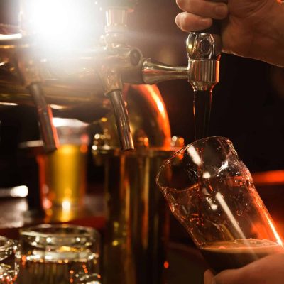 close-up-bartender-pouring-beer